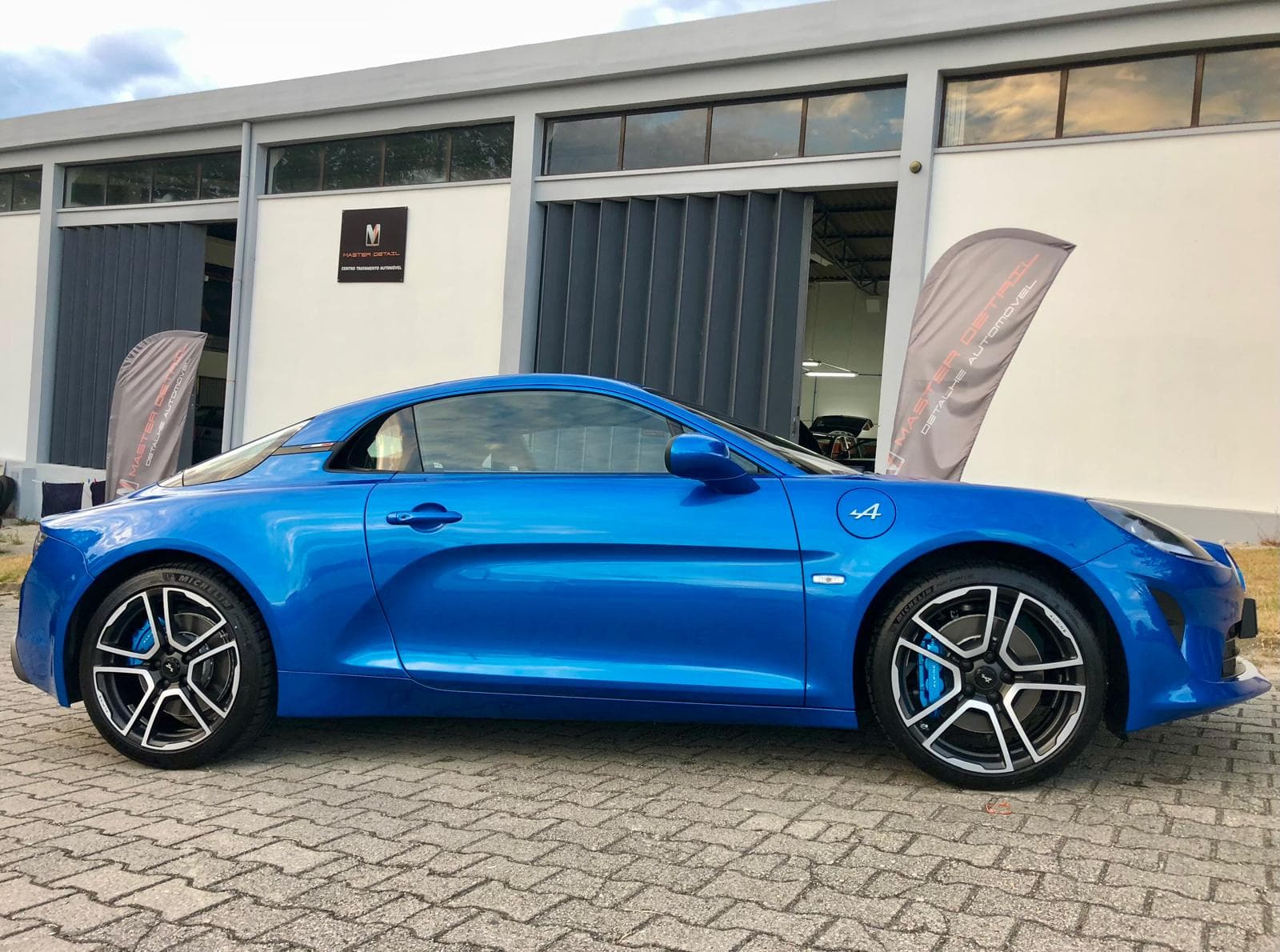 Blue Alpine A110 sports car after professional detailing