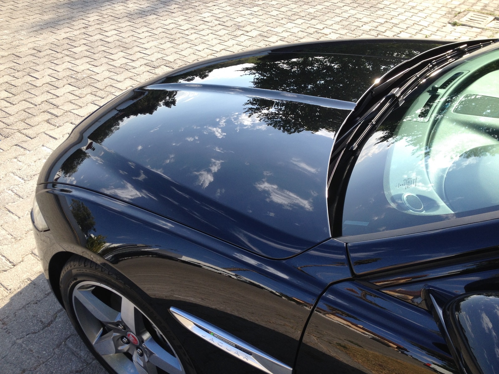 Dark blue Jaguar showing mirror-like reflections after ceramic coating