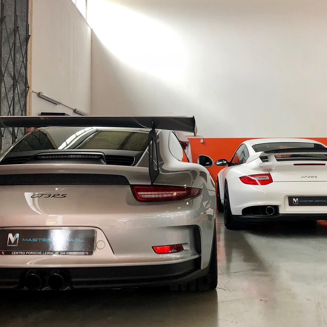 Two white Porsche GT3 RS and GT2 RS in showroom
